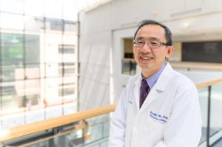 This is a photo of Markey medical oncologist Zhonglin Hao, M.D., Ph.D., who is leading the clinical trial for an mRNA vaccine to treat lung cancer. Photo by Shaun Ring.