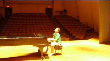 Student at one of the grand pianos in the Recital Hall.